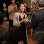Community leader receiving an award on stage