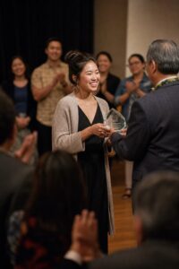 Community leader receiving an award on stage