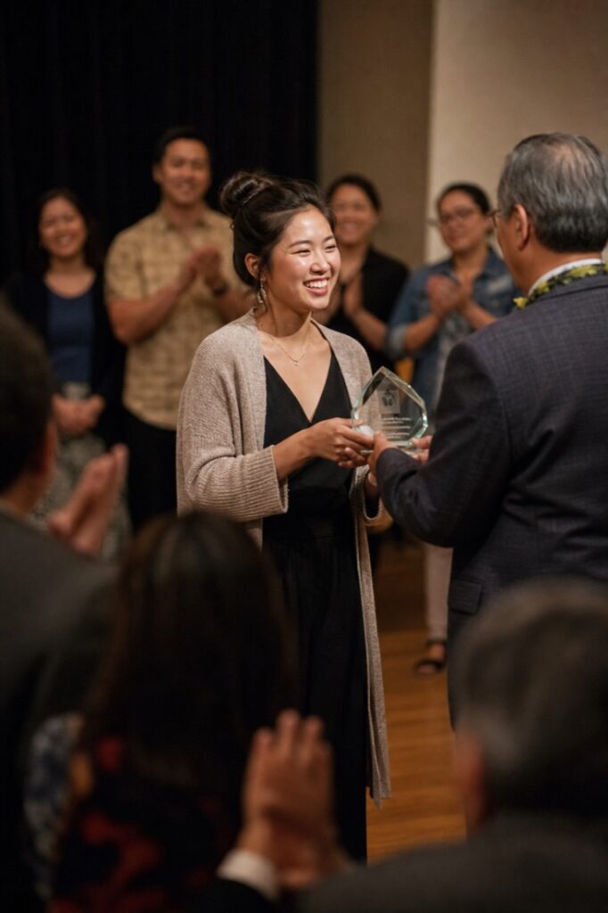 Community leader receiving an award on stage